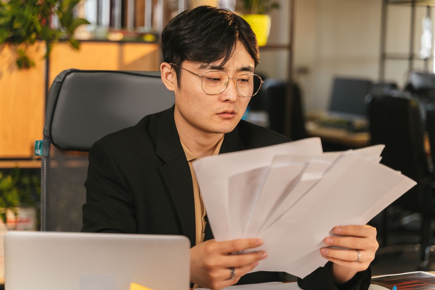 A manager reviewing papers at a desk