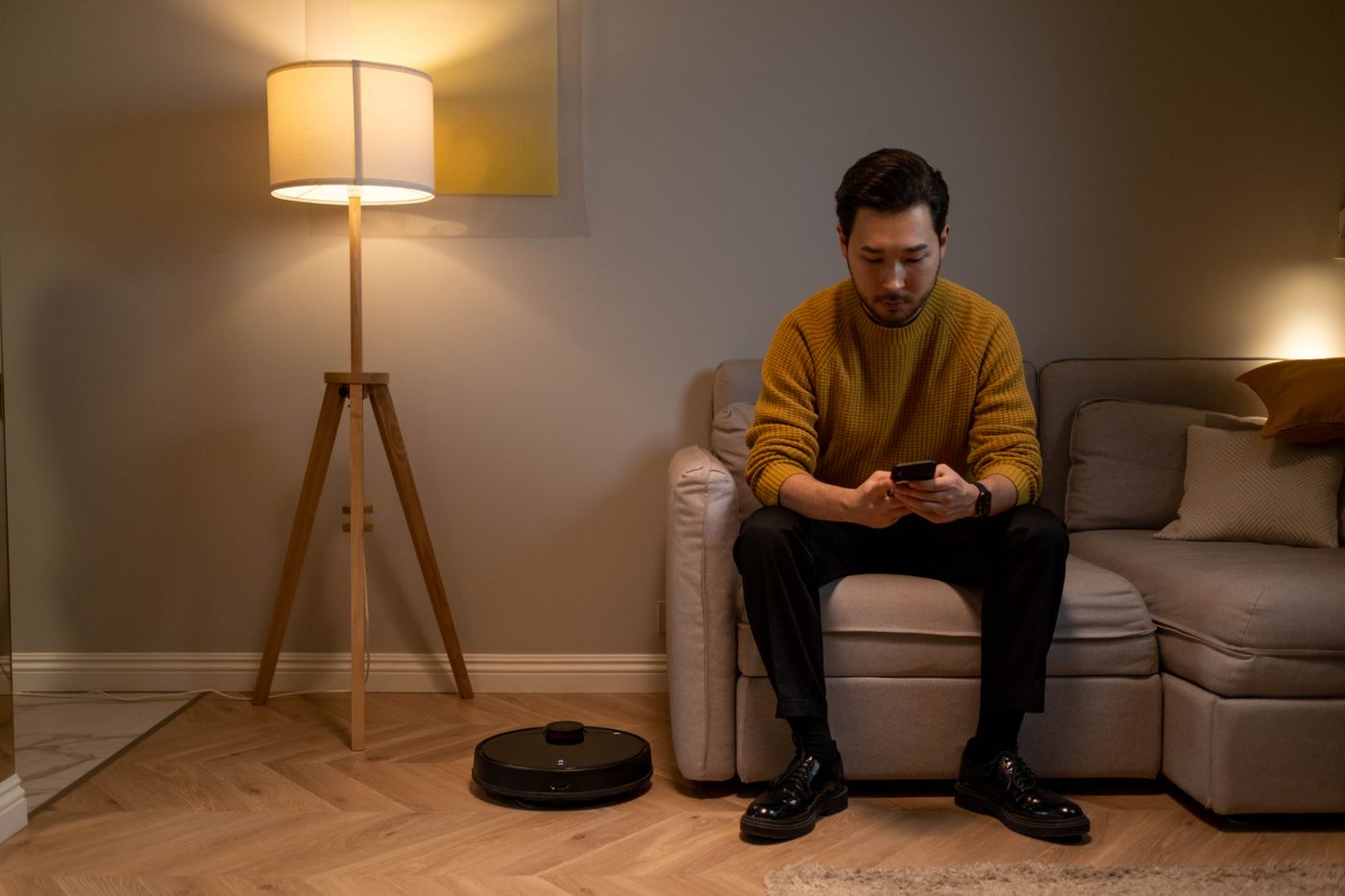 A person using a phone on a sofa at home