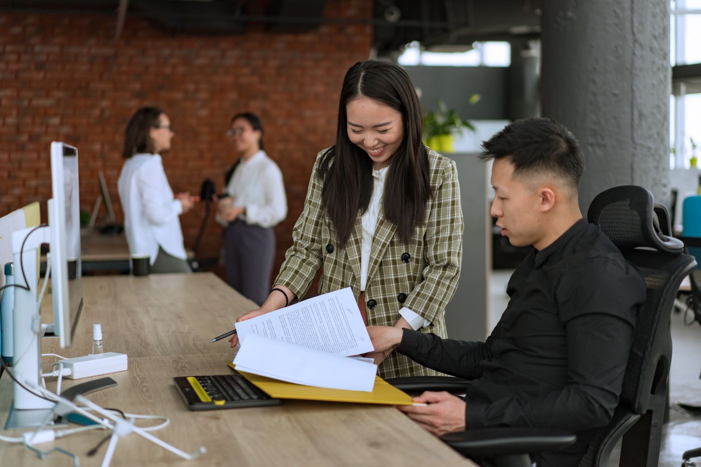 Colleagues reviewing documents together at an office desk