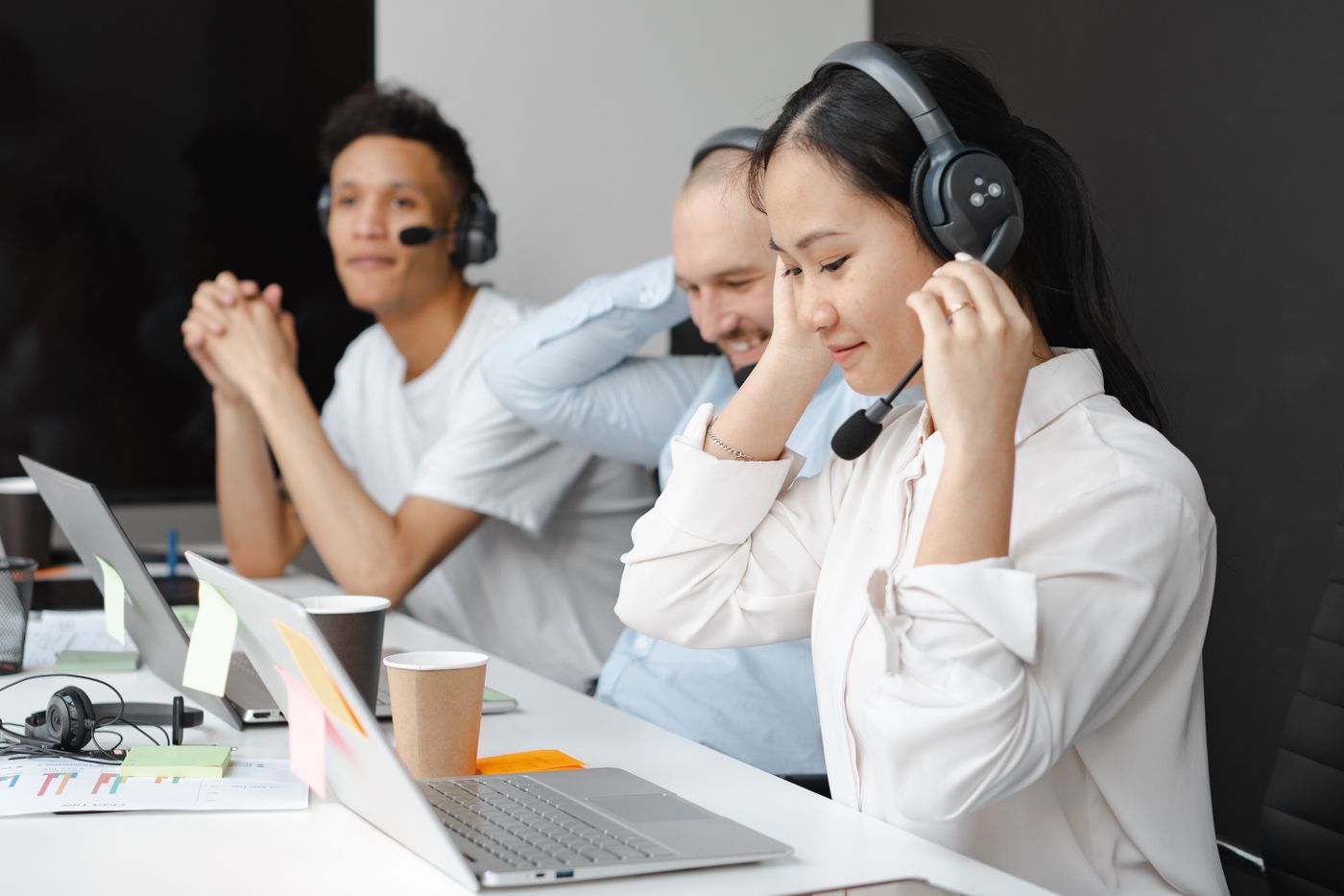 Members of a support team on calls at their desks